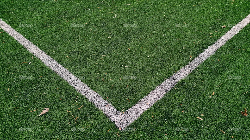 white markings on the green grass of a football field