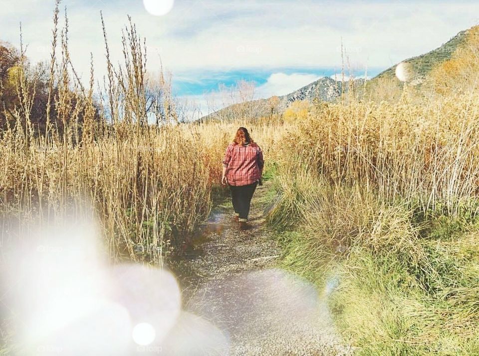 girl walking through a field