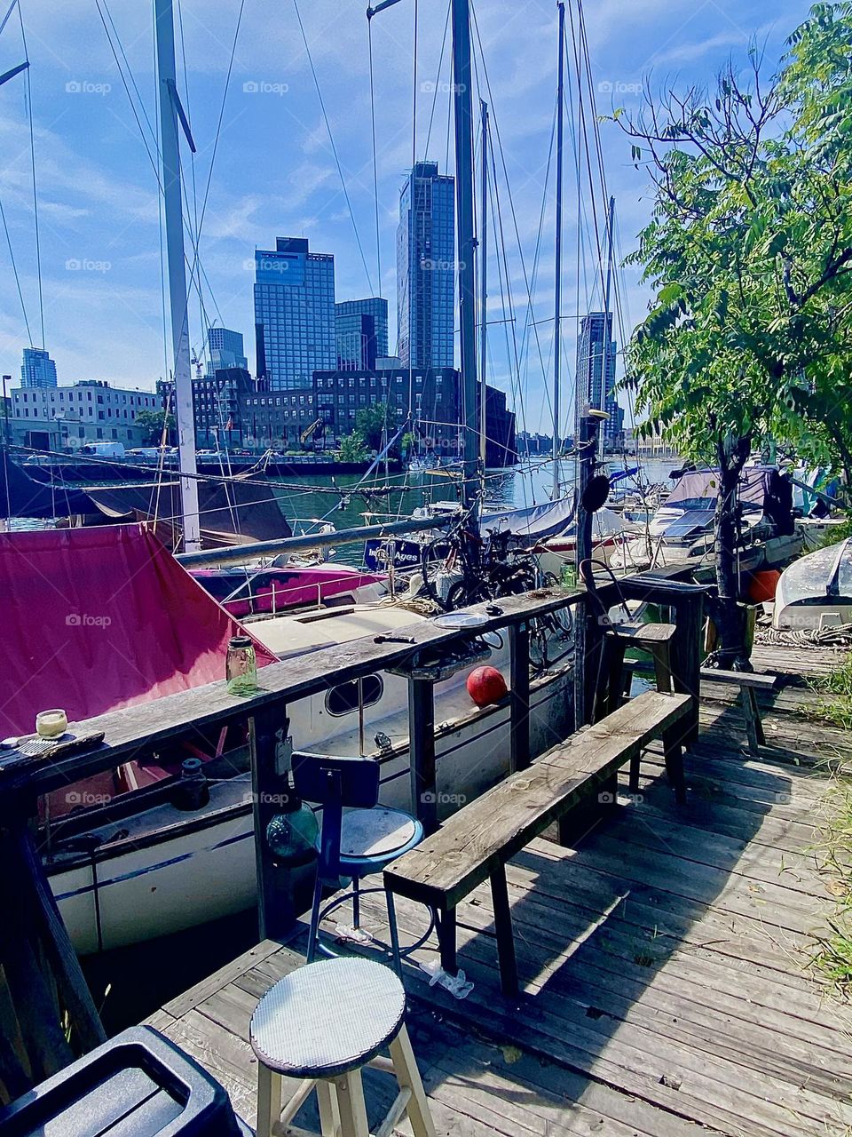 This is the sailboat that carries three bicycles tied to its deck. It is positioned directly next to the handmade wooden veranda that serves as a venue for barbecues, parties or get togethers. 2023. Hypnotic Productions