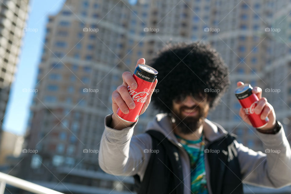 Cute guy with Coca-Cola. Creative boy with Coca-Cola. Amazing man walking at the street 