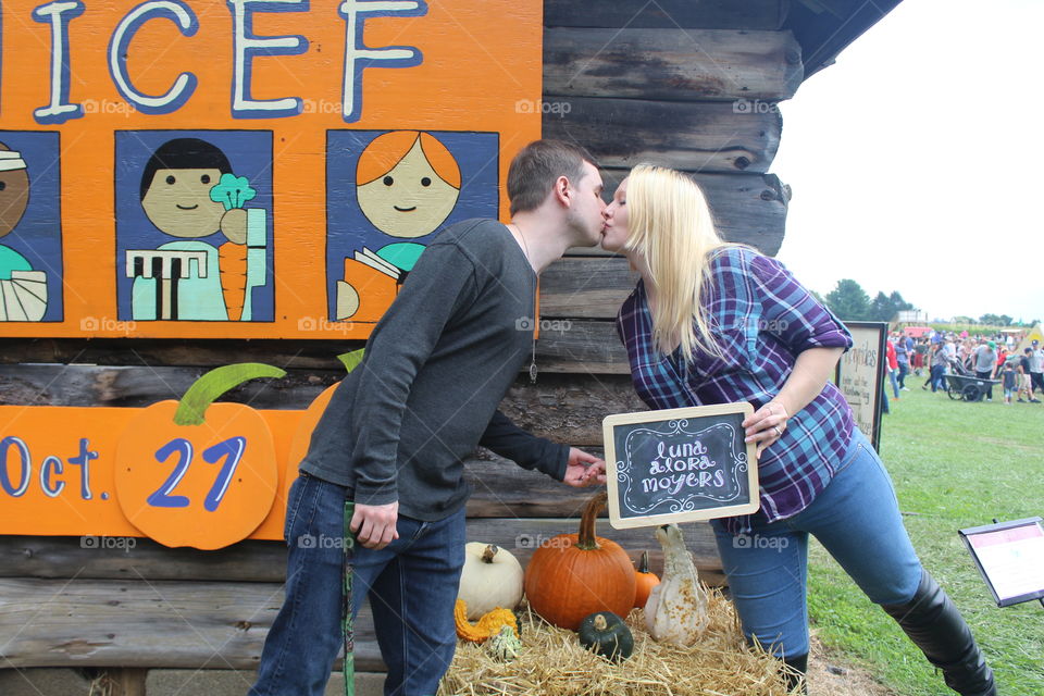 Stealing a kiss during pumpkin picking 