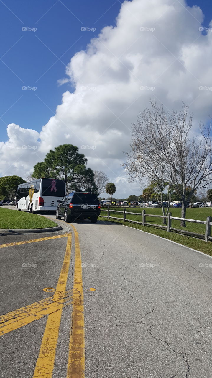 bus traveling one lane park fair festival suv