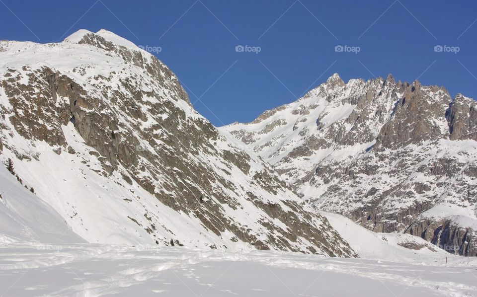 Mountains covered by the snow against clear sky