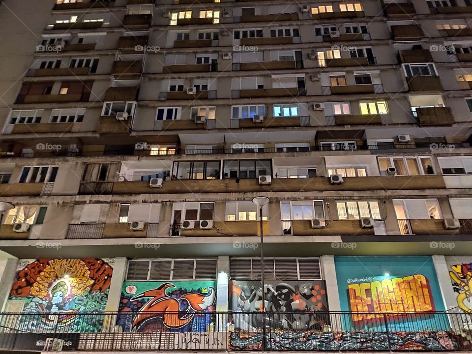 Belgrade Serbia street graffiti on resident building by night