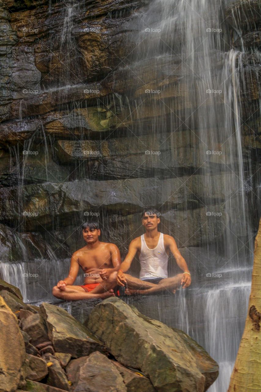 Enjoying the summer under man made waterfall