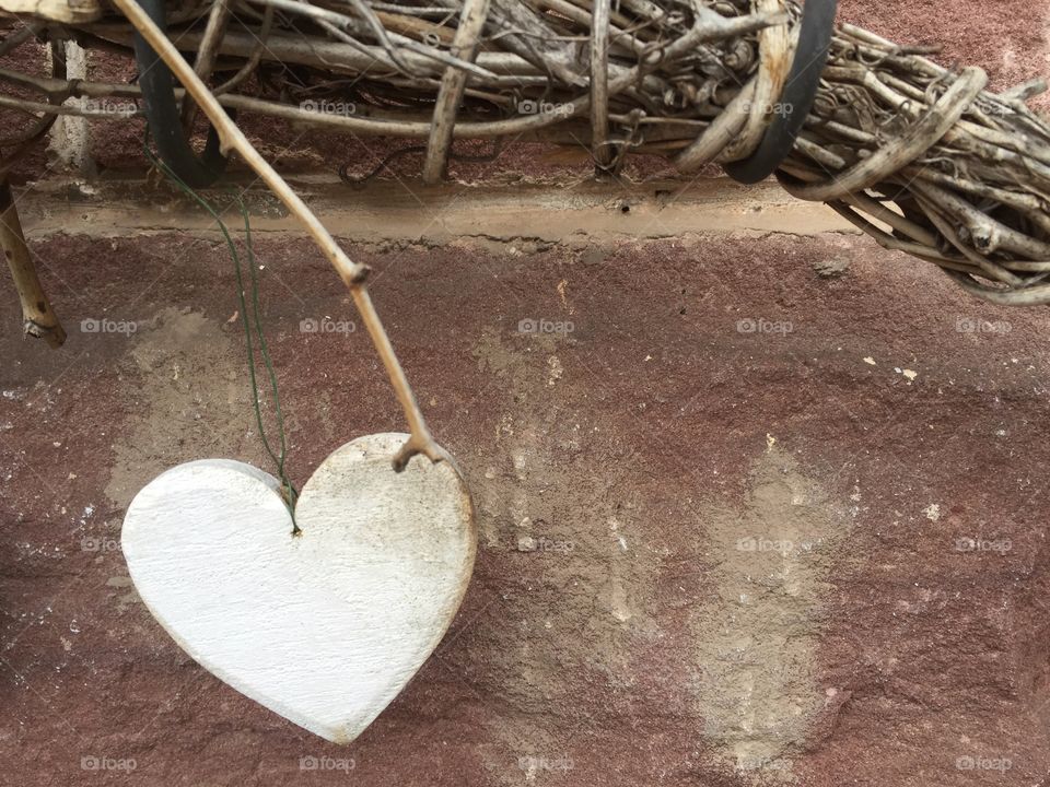 White heart in front of wall 