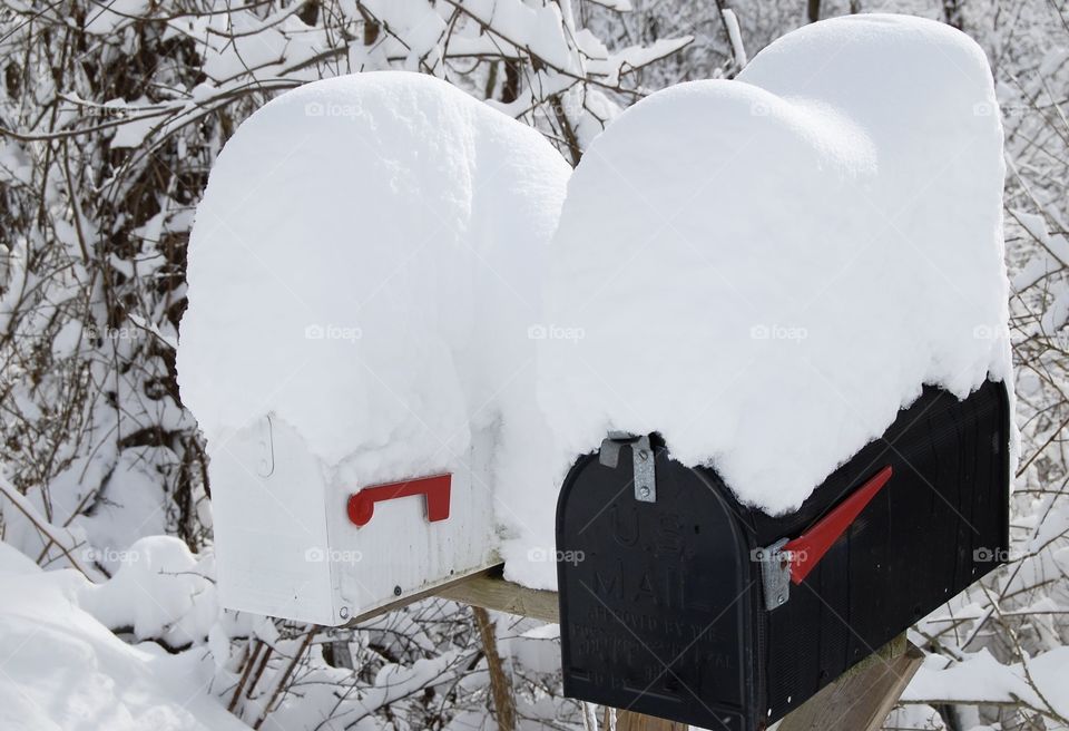 Lots of snow on top of mailboxes 