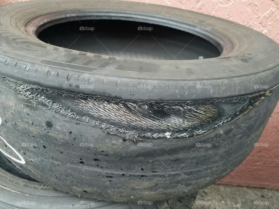 A Very Worn Out Car Tire Showing Steel Tread