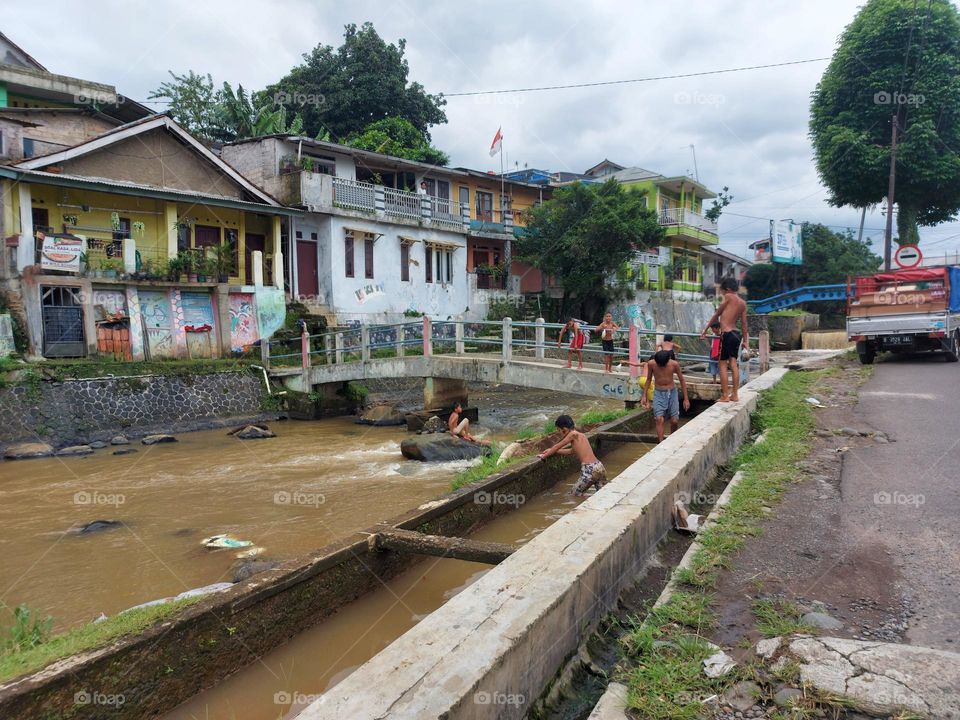A group of children playing and fishing in the river, Bogor Indonesia