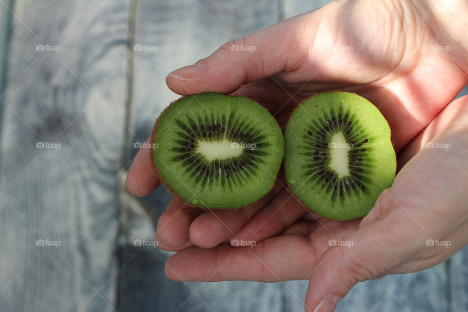 Hands, female hands, kiwi in hands, kiwi fruit, still life, abstraction