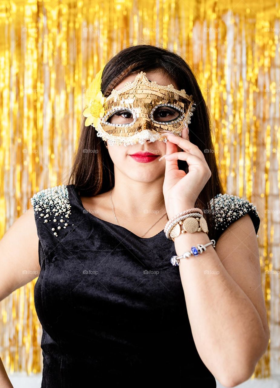 woman wearing golden mask on costume party