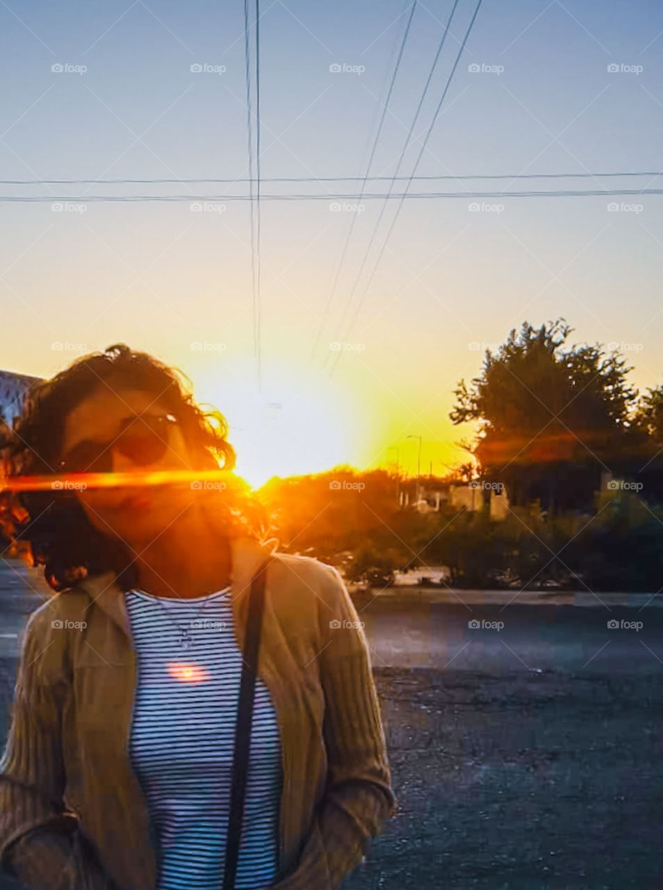 sun rays illuminating girl smiling by the road