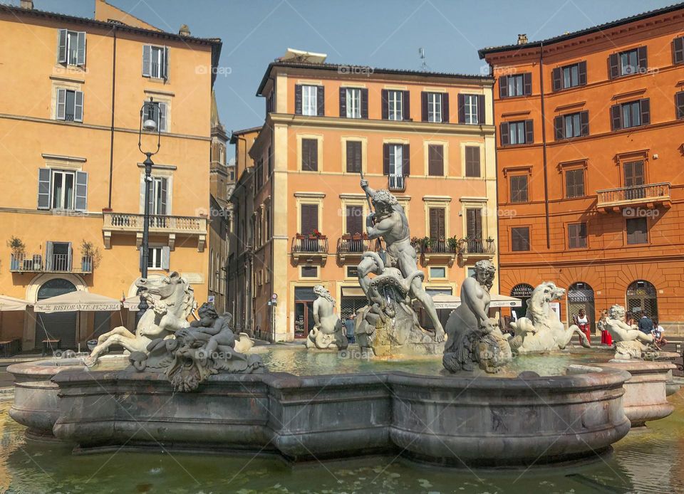 Yellow and orange buildings and beautiful fountain in Rome