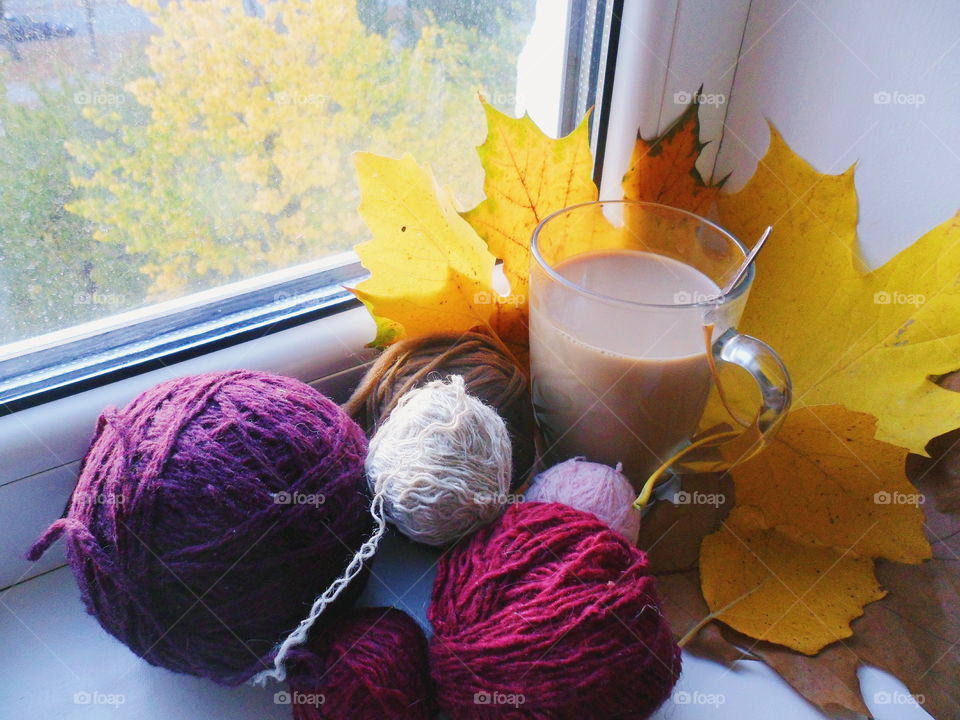 a cup of hot chocolate and warm socks on the windowsill