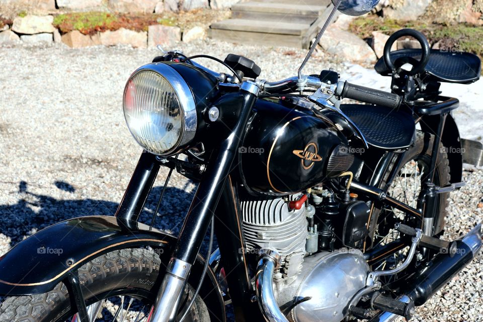 Old black motorcycle at outdoors