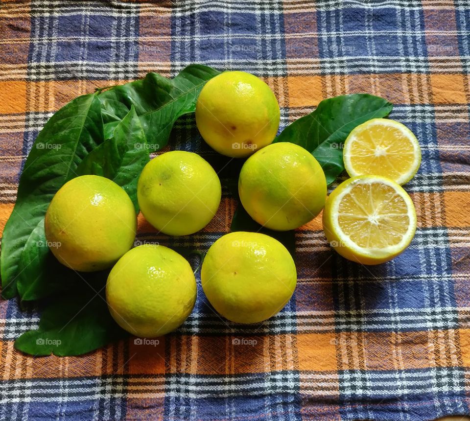 yellow ripe , citrus sweet limes on a kitchen table