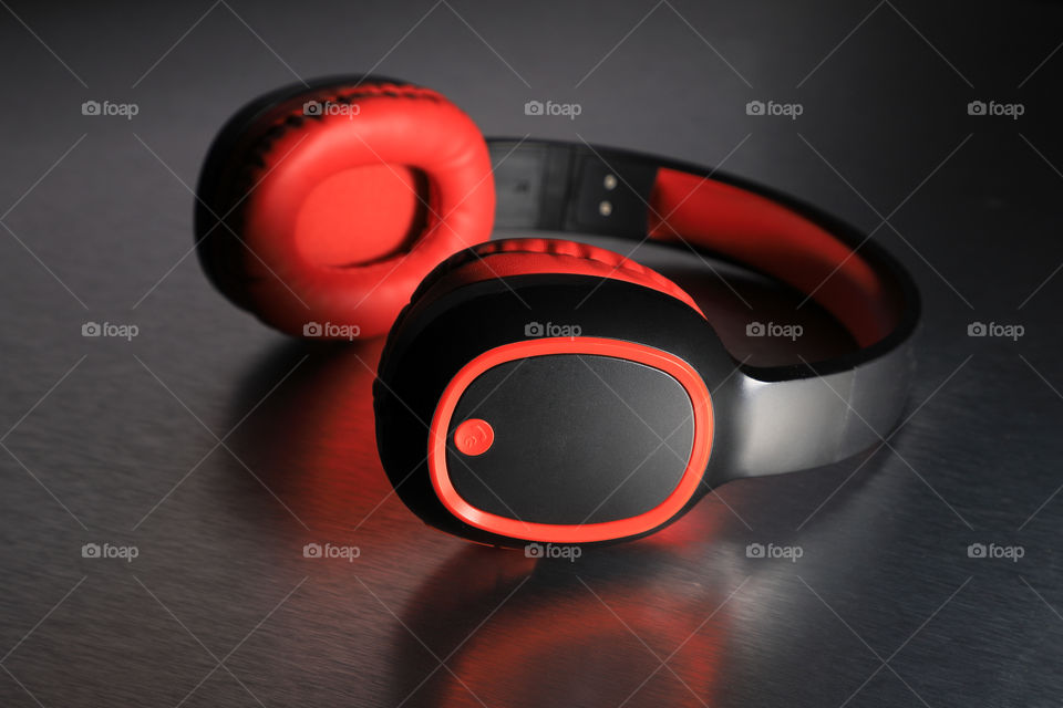 Bluetooth wireless headphones on reflective background