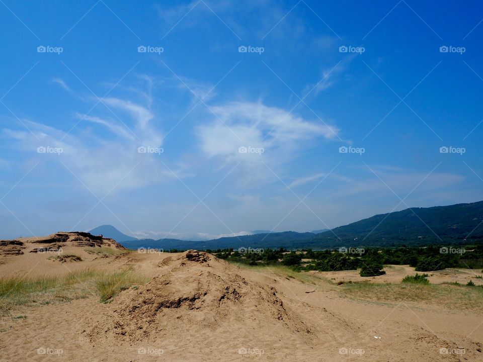 Issos beach sand dunes, lake korrission and mountains in the distance, Corfu, Greece