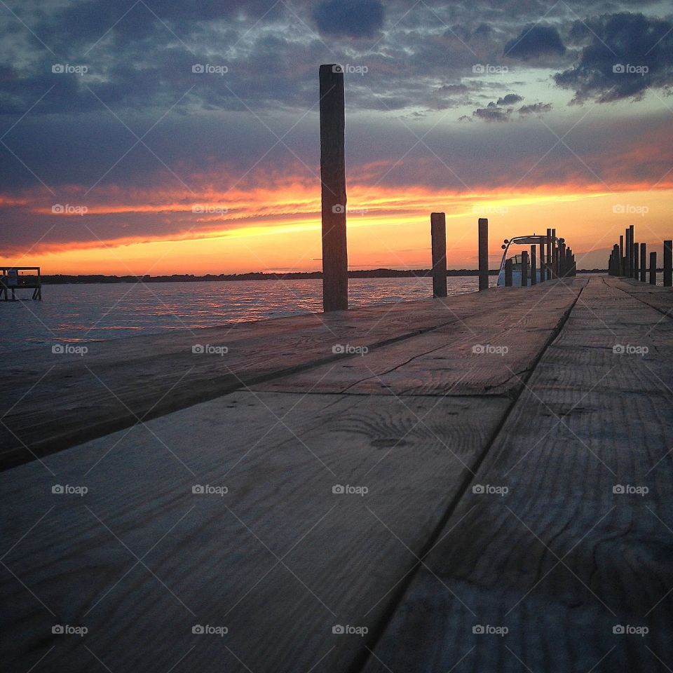 Summer nights. Photo of the sunset from the dock of the lake