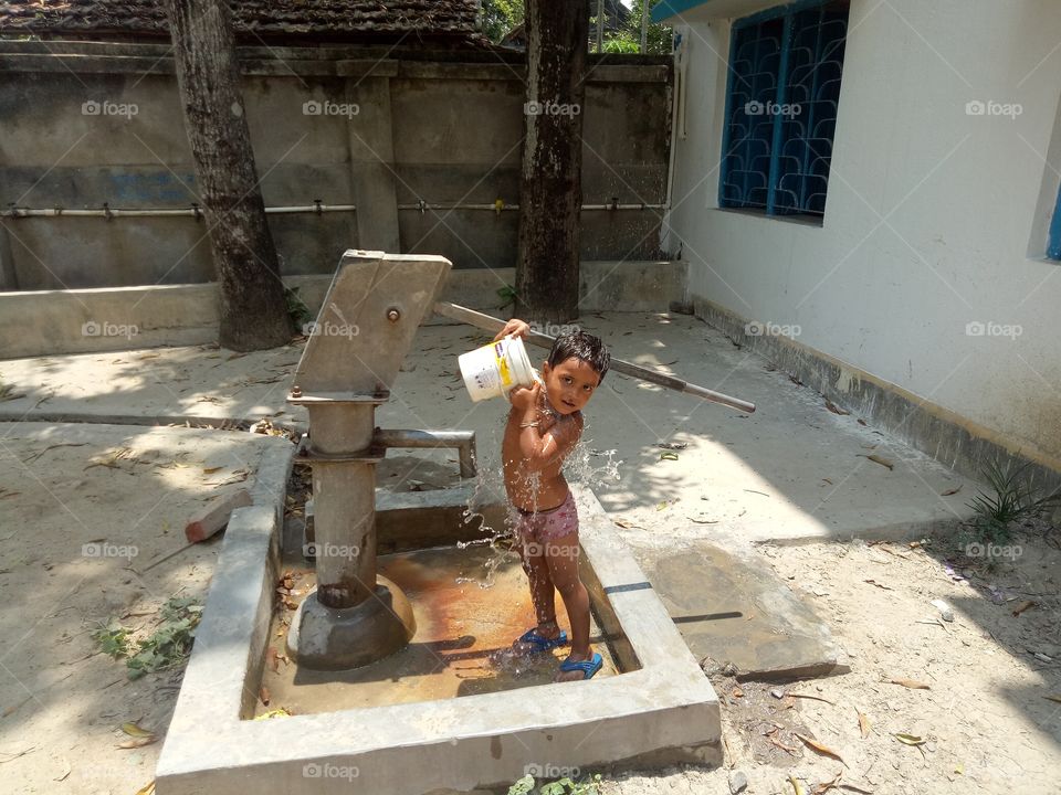 Little kid is bathing...own mind.....it looks very nice..she is very happy....