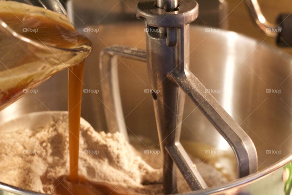 Pouring wet ingredients into dry ingredients in a stand mixer