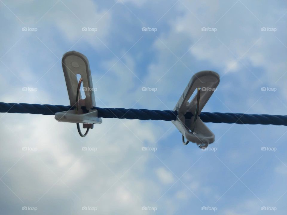 Clothespins, clotheslines against the sky background