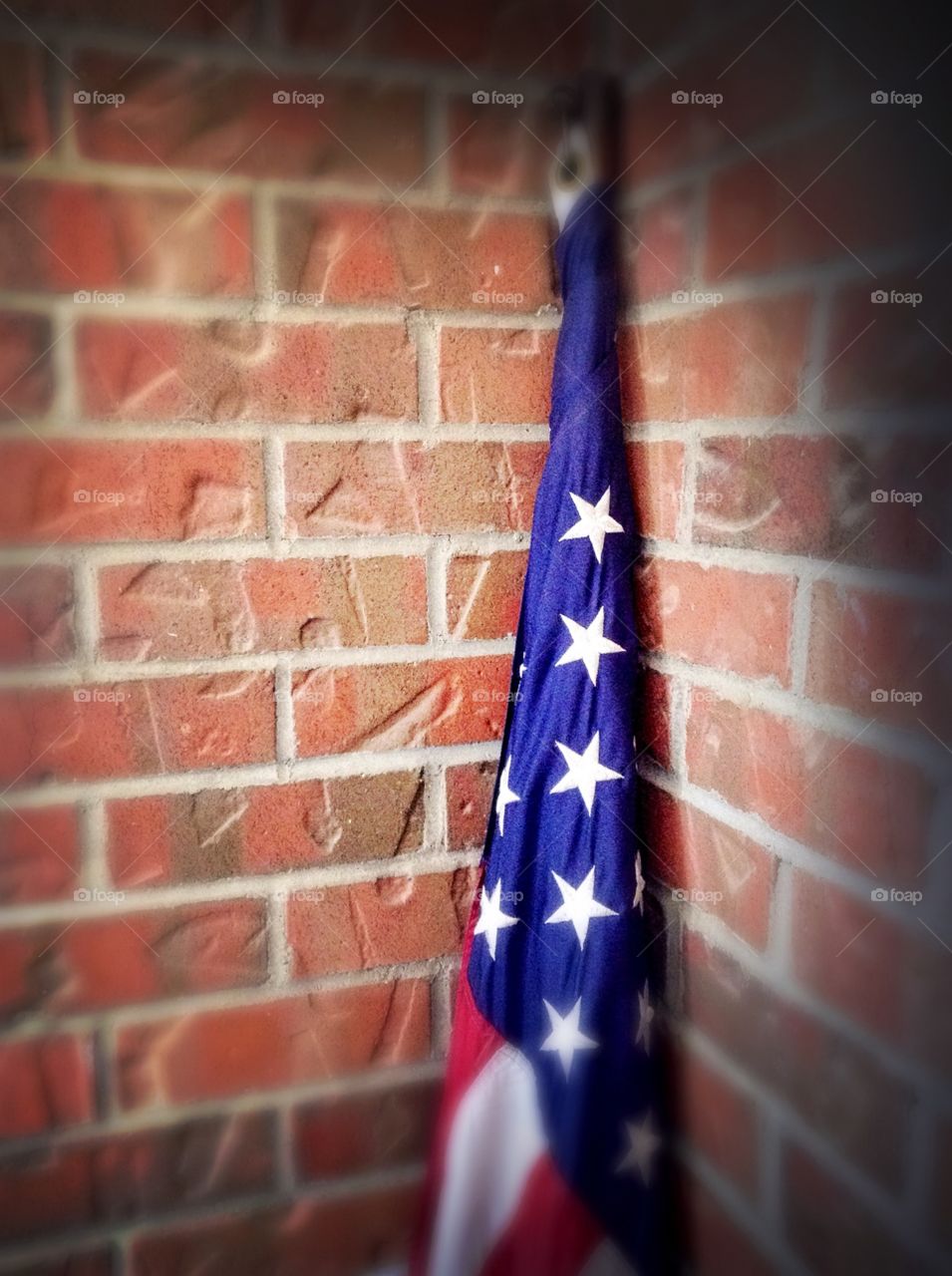 Old Glory against brick wall