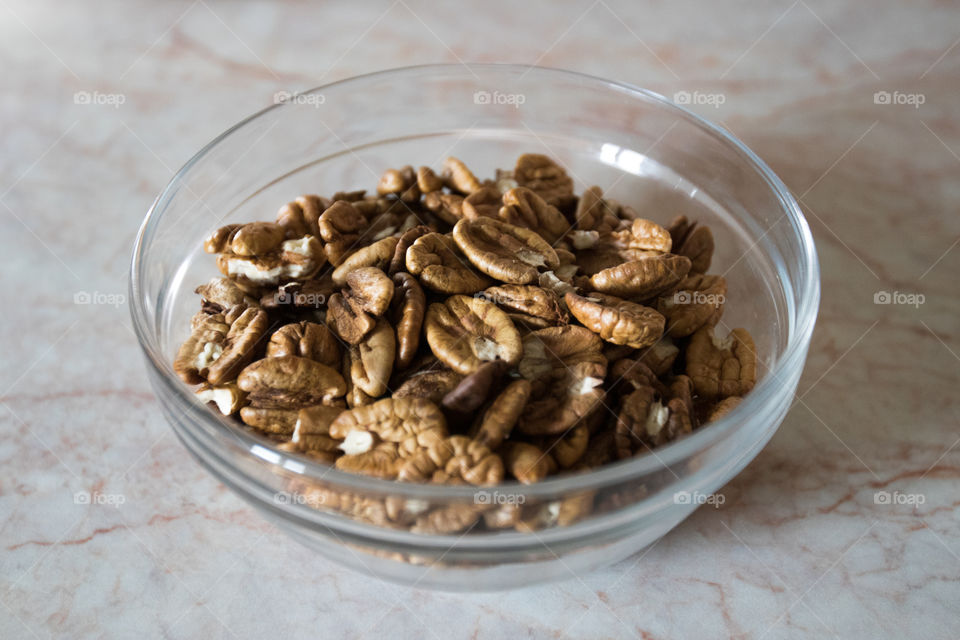 fresh picked bio walnuts as healthy snack in a glass bowl