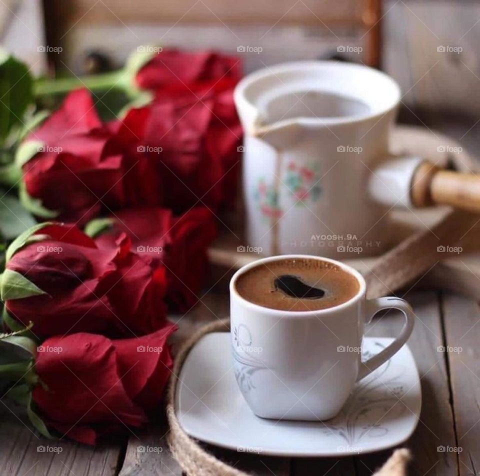 Serve a cup of coffee with flowers and orange slices