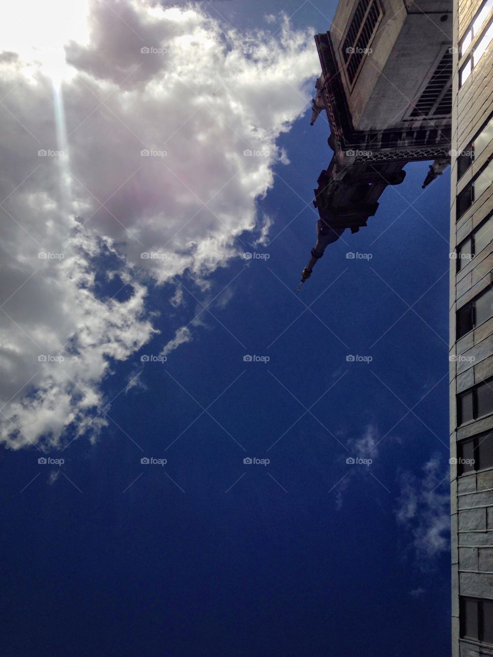 Blue sky and a cloud. Gardens of St Paul's cathedral. London. View up in the sky while laying on the grass