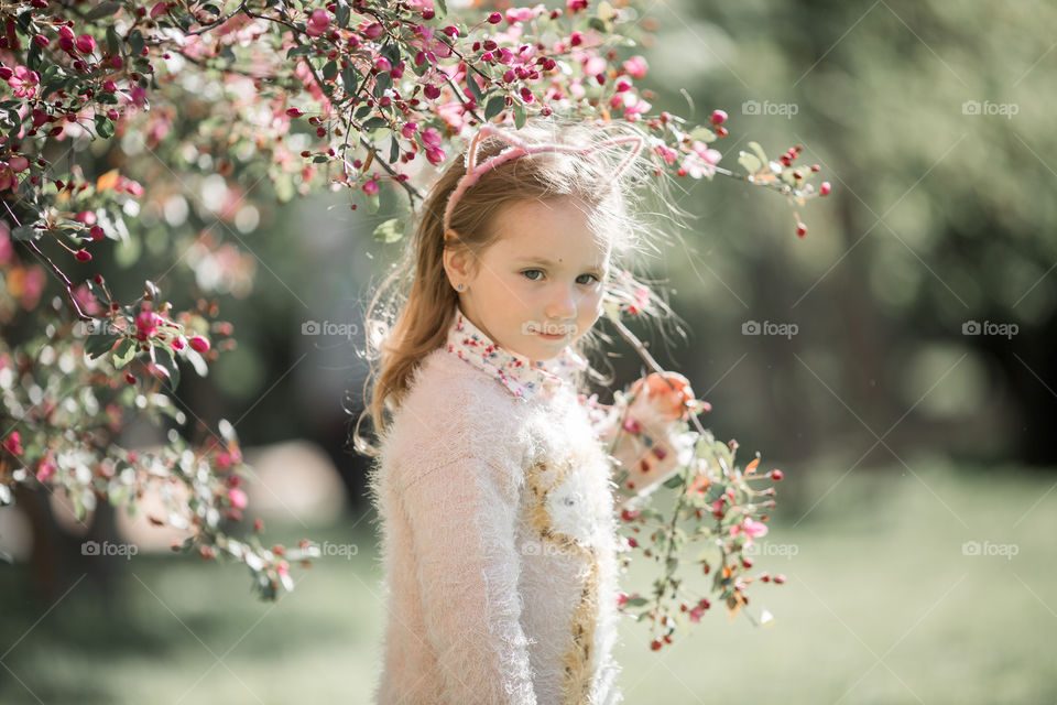 Cute Little girl in a blossom park