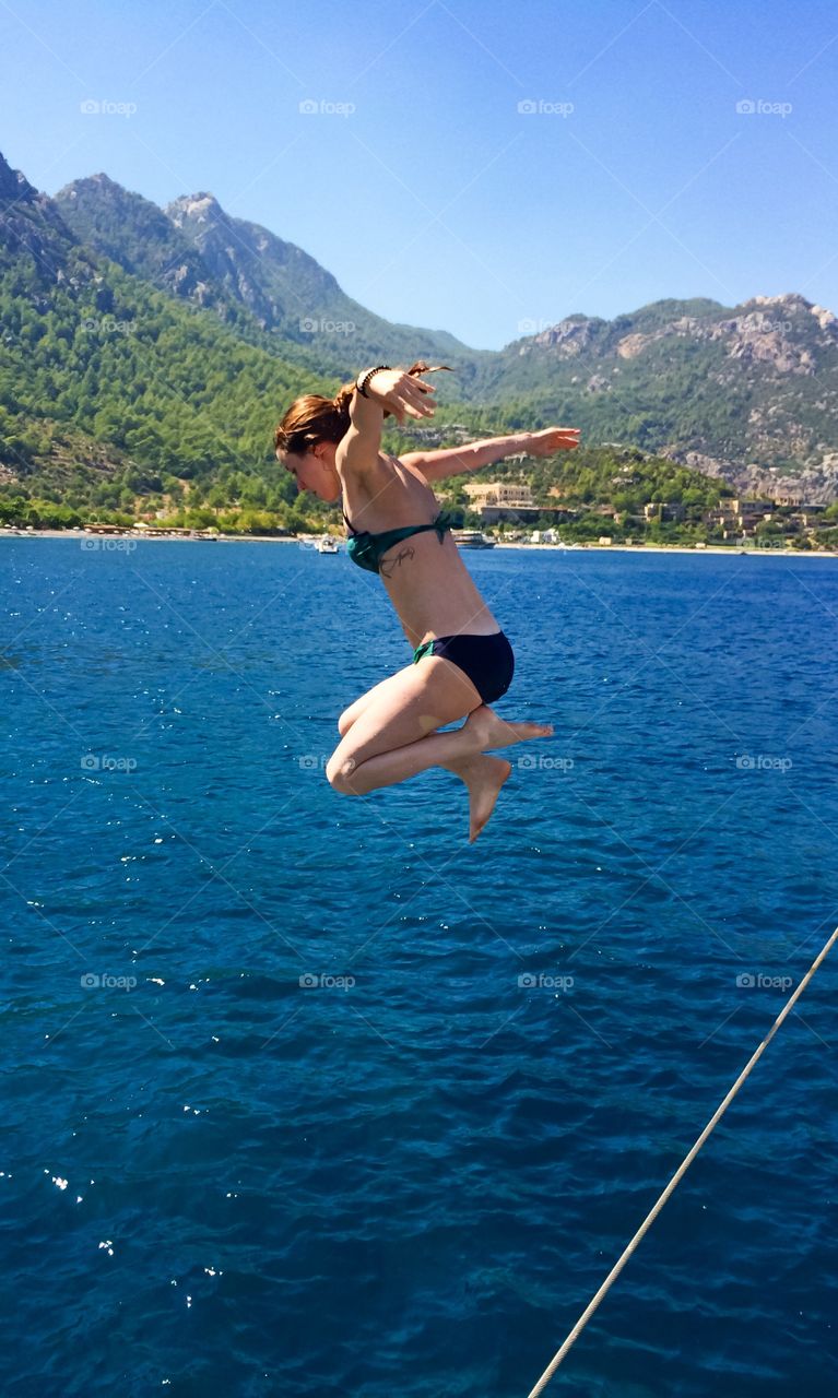 Woman jumping in sea