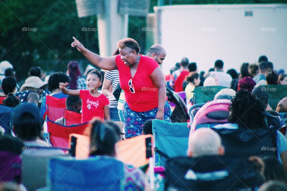 Grandmother and grand daughter having fun dancing together at summer festival 