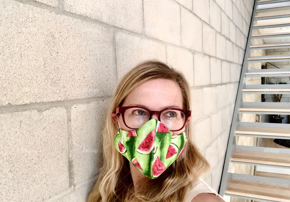 Woman in watermelon face mask showing off the lates summer 2020 fashion, Los Angeles CA 6.12.2020