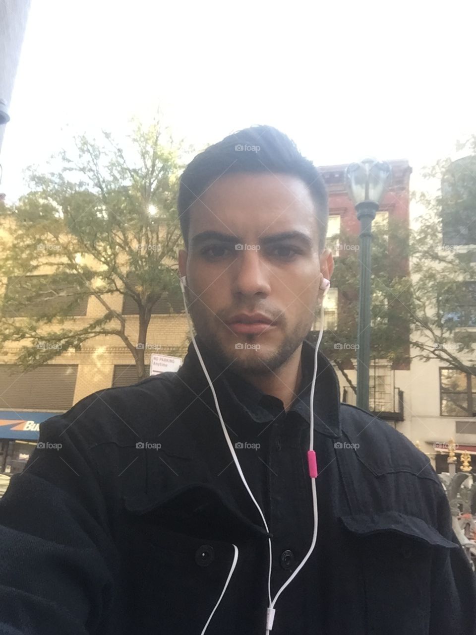 Model selfie with apple earphones in the city .