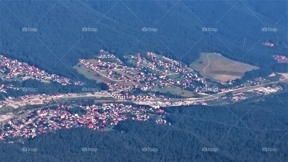 Overview of Romanian town seen from the top of the mountain.