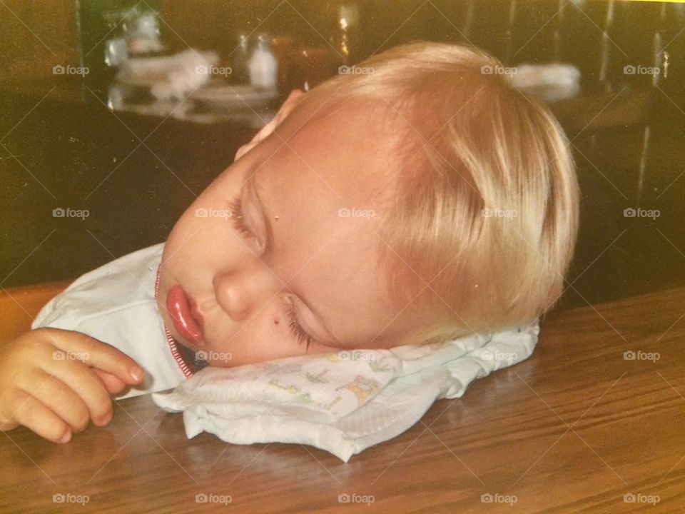 A little boy sleeping on desk