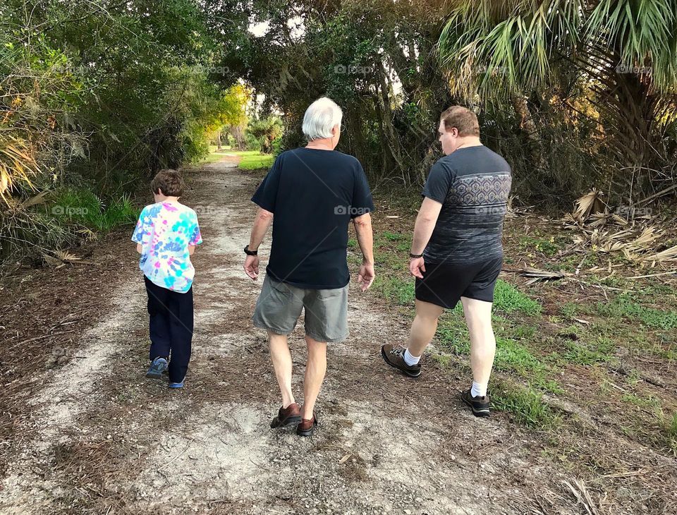3 generations of family taking a walk through the woods.