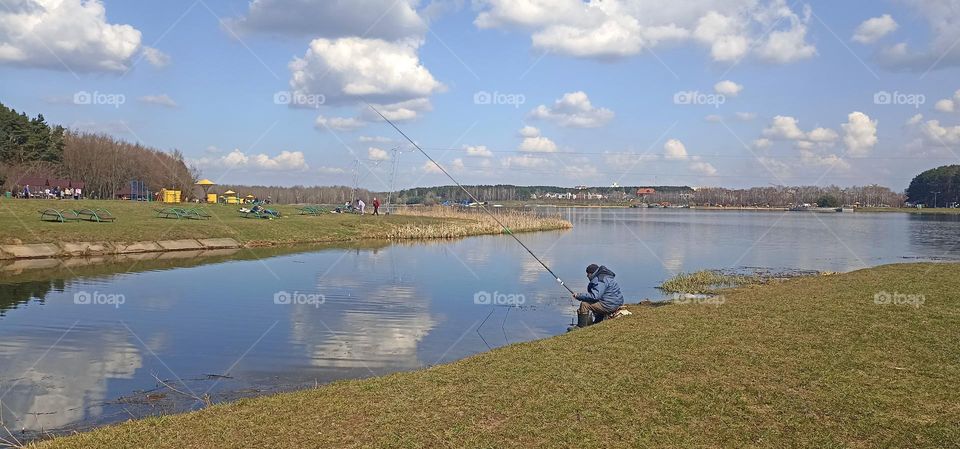 fisherman on a lake shore beautiful spring nature landscape