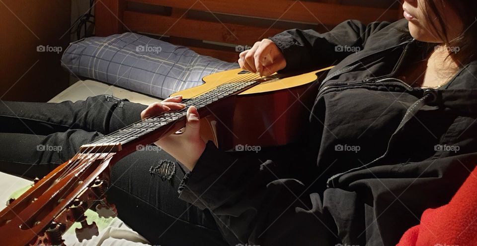 A moment in our personal space, playing the guitar, a very beautiful musical instrument and a spectacular sound