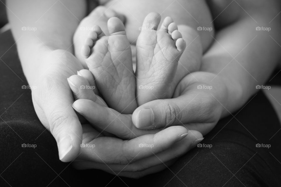 Human hand with babies foot
