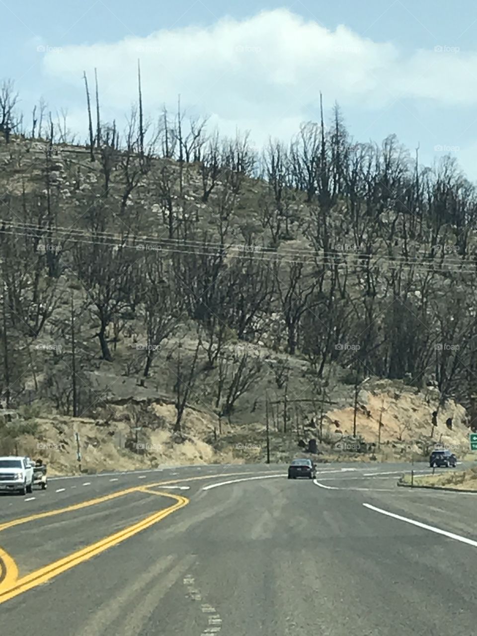 The aftermath of a wild fire in the mountains. This scenario has a haunting looks to it.