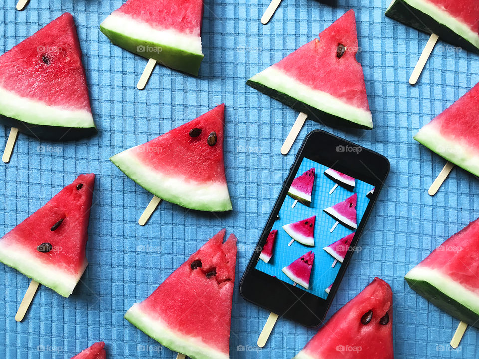 Triangles of red watermelon on blue background 