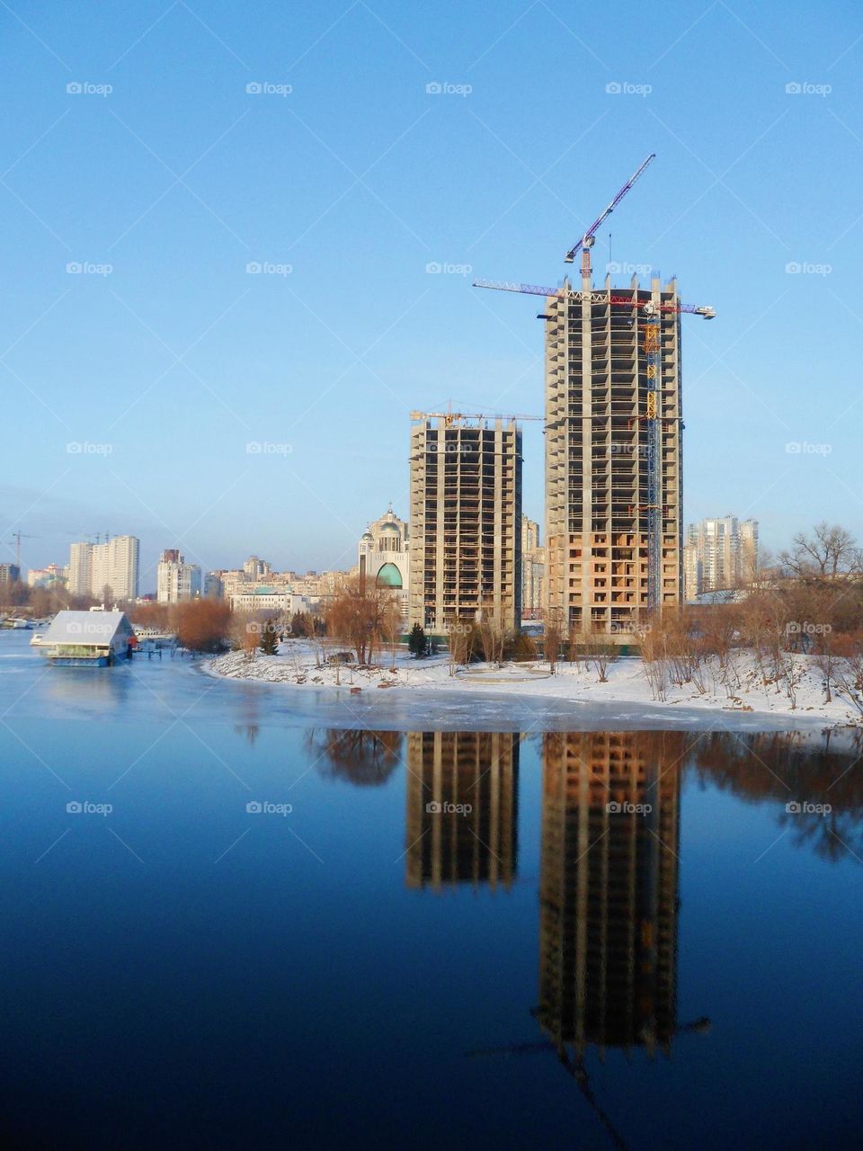 reflection in the water of unfinished buildings