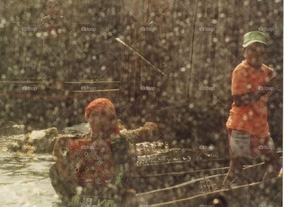 Caribbean boatmen in the rain