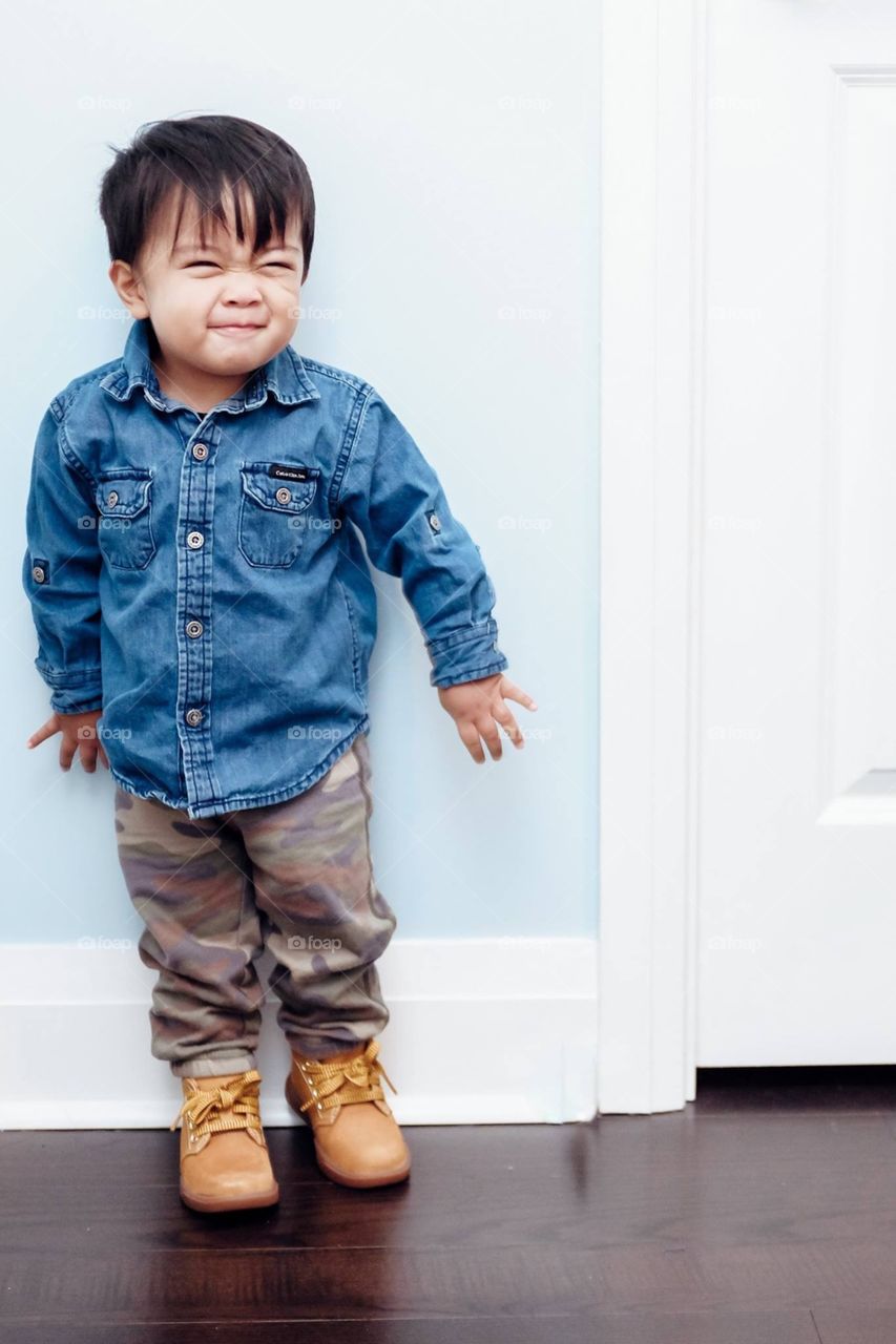 Cute boy leaning on wall