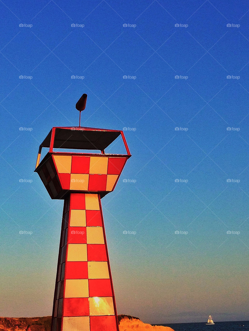 Red-and-white checkered aviation safety pylon at an airfield