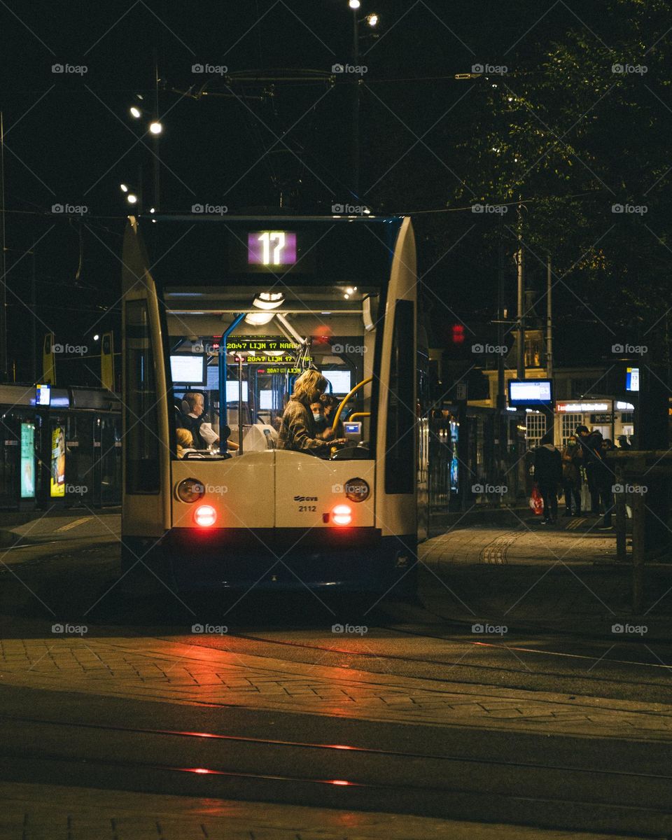 Woman getting off the tram on a winter night