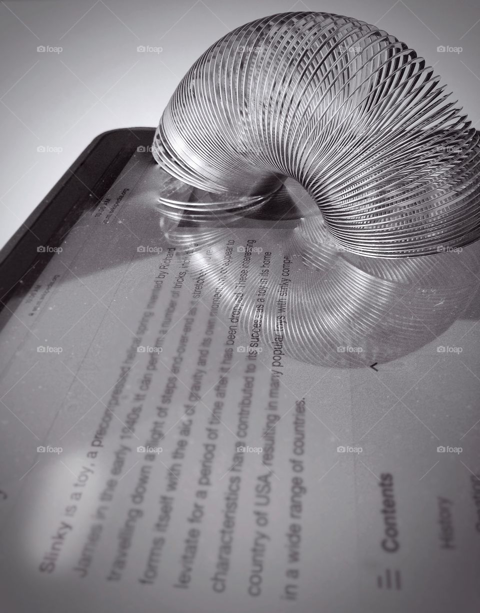 Slinky toy. Slinky toy on a tablet