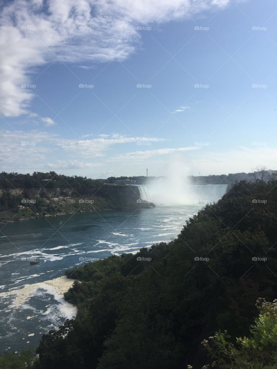 Mist ascending towards the heavens from the amazing falls of Niagara on a wonderful clear day